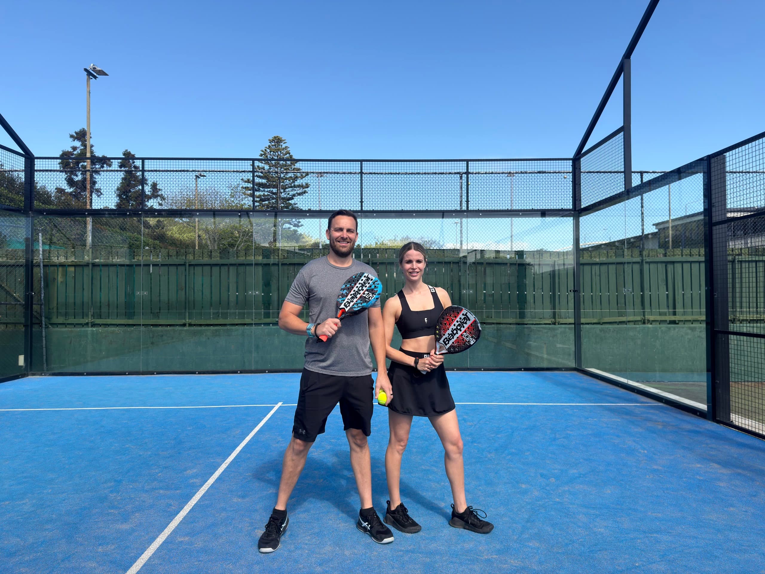 Two players on a padel court