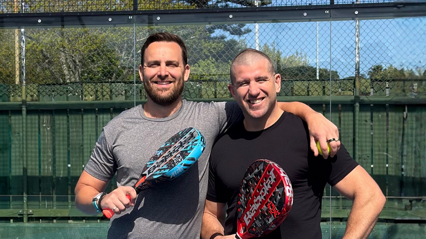 Thomas Price on the left and Gareth Tipene on the right, standing together on a padel court with rackets